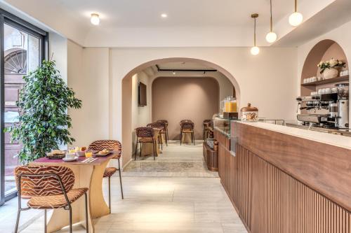 a restaurant with a table and chairs in a room at Hotel Fori Imperiali in Rome