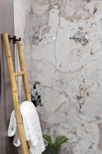 a towel rack in a bathroom with a marble wall at SUITE ELEVEN ISOLA D'ELBA in Bagnaia