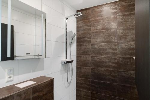 a bathroom with a shower with a glass door at Strandhus 22 in Graal-Müritz
