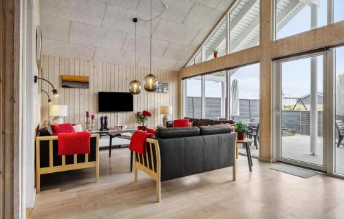 a living room with a couch and a table at Stunning Home In Bogense With Sauna in Skåstrup