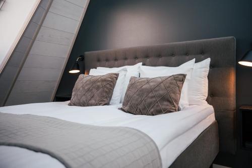 a bedroom with a bed with two pillows at Glass Resort in Rovaniemi
