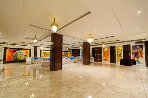 a banquet hall with tables and chairs in a building at Eastlynn Resort Rishikesh in Rishīkesh
