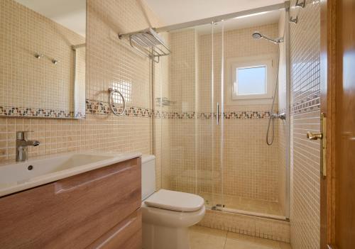 a bathroom with a toilet and a shower and a sink at Apartments MTB Only Couples in Lloret de Mar