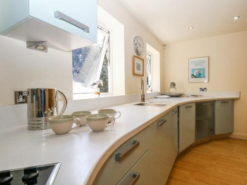 a kitchen with a sink and a counter top at 6 Red Sails in Poole