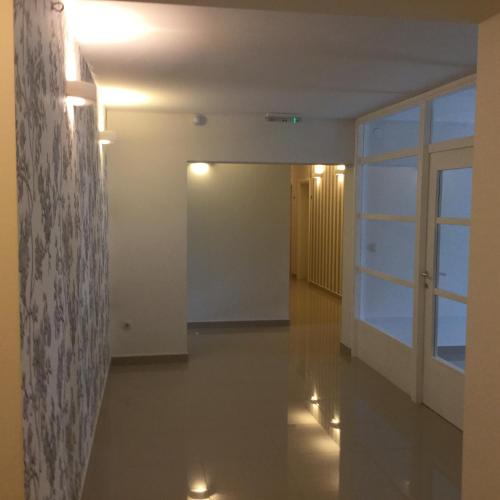 a hallway of an empty room with a window and lights at Pansion Bencun in Međugorje