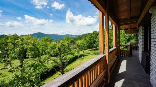 a porch with a view of the mountains at Hiša na Hribu- A Peaceful Hilltop Escape above river Kolpa in Kostel