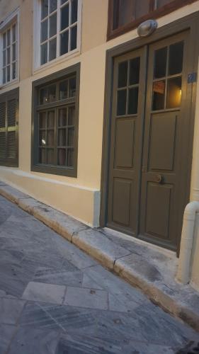 a building with a door on the side of it at ERRIKA in Ermoupoli
