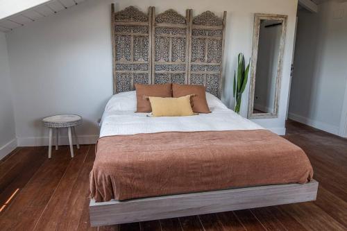 a bed with two pillows on it in a room at Casa Rural Camino Blanco in Burgos