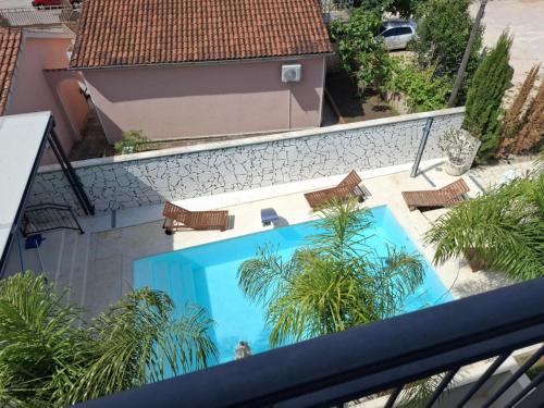 an overhead view of a swimming pool with chairs and trees at Luxury Aparthotel Zadar in Zadar