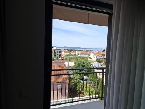 a window with a view of a city at Luxury Aparthotel Zadar in Zadar