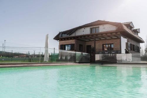 a building with a pool of water in front of it at Casa Rural Camino Blanco in Burgos