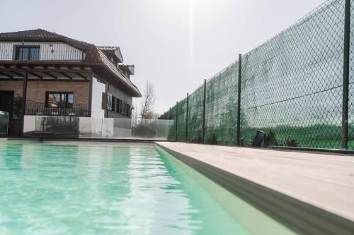 an empty swimming pool with a fence at Casa Rural Camino Blanco in Burgos