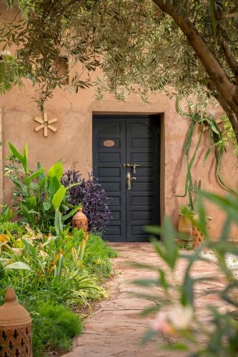 a blue door of a house with a garden at Villa Sidi Oasis in Marrakech