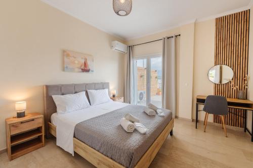 a bedroom with a bed with two towels on it at Christina's apartment 2 in Kontokali