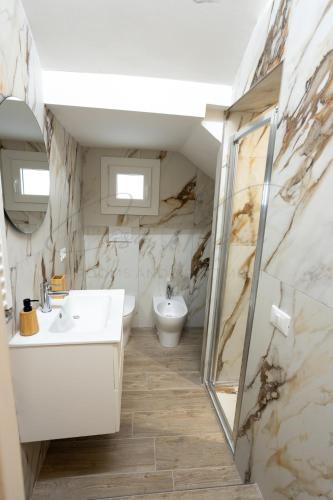 a bathroom with a sink and a toilet at Nadia Apartment in Chioggia