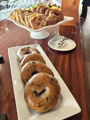 a plate of bagels and pastries on a table at Linekin Bay Resort in Boothbay Harbor