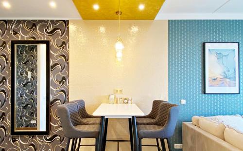 a dining room with a table and a couch at Papiniidu Apartments in Pärnu