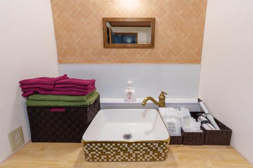 a bathroom with a sink and a mirror and towels at Y'sINN 宮城野 040H in Hakone