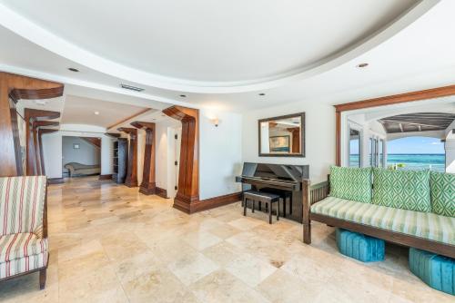 a living room with a piano and a couch at Pease Bay House in Breakers