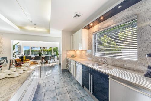 a kitchen with a sink and a large window at Pease Bay House in Breakers