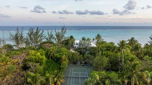 an aerial view of a tennis court in front of the ocean at Pease Bay House in Breakers