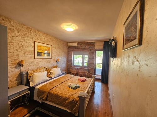a bedroom with a bed and a couch in it at Medin Apartments BluVista in Petrovac na Moru