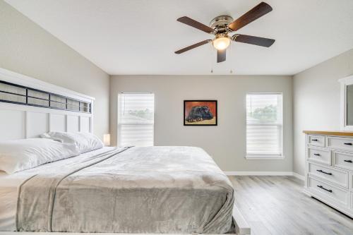 a bedroom with a bed and a ceiling fan at Hike, Paddle and Explore Home with Lanai in Ocala in Ocala