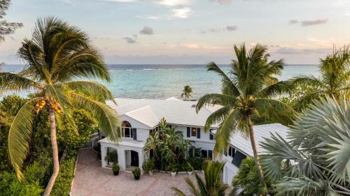 an aerial view of a white house with palm trees at Pease Bay House in Breakers
