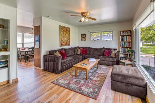 a living room with a couch and a table at Walk to Flathead Lake Airy Home with Mtn Views! in Polson