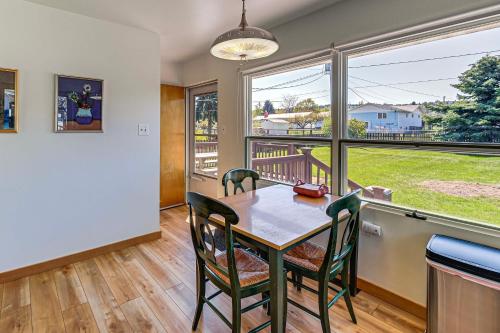 a dining room with a table and chairs and a large window at Walk to Flathead Lake Airy Home with Mtn Views! in Polson