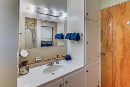 a bathroom with a sink and a mirror at Walk to Flathead Lake Airy Home with Mtn Views! in Polson