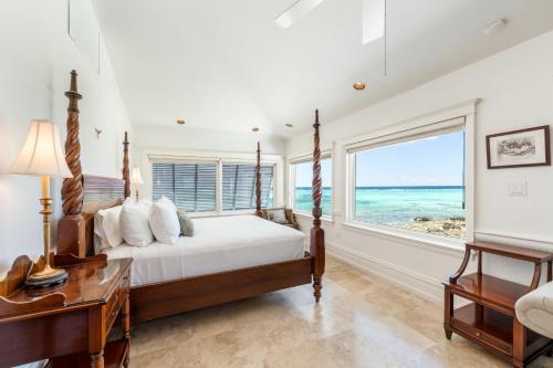 a bedroom with a bed and a view of the ocean at Pease Bay House in Breakers