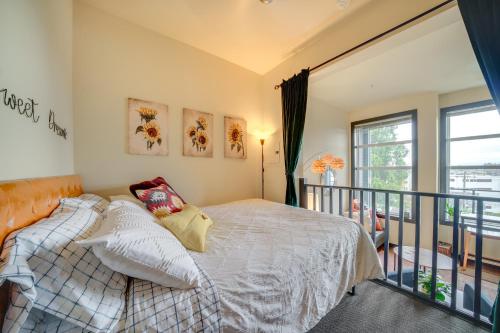 a bedroom with a bed and a balcony at 1 Mi to Dtwn Seattle Condo with Garage Parking in Seattle