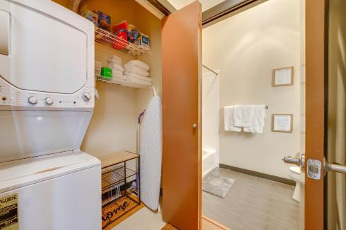 a small kitchen with a refrigerator and a walk in closet at 1 Mi to Dtwn Seattle Condo with Garage Parking in Seattle
