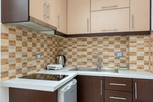 a kitchen with a sink and a counter top at Villa JIOTA in Ksamil
