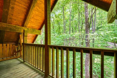 a porch of a cabin with a view of the woods at 2 Mi to GSMNP Peaceful and Scenic Cabin with Deck in Sevierville