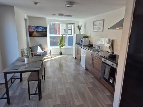 a kitchen with a table and a dining room at 248 Halls in Middlesbrough