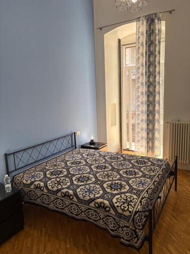 a bedroom with a bed in a room with a window at Rosabella Visconti in Bari