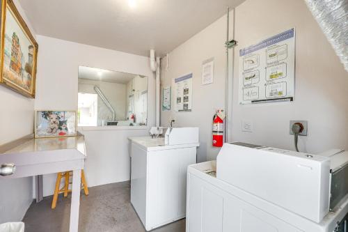 a laundry room with white appliances and a sink at 9 Mi to Pompano Beach Condo with Resort Perks! in Lauderdale Lakes