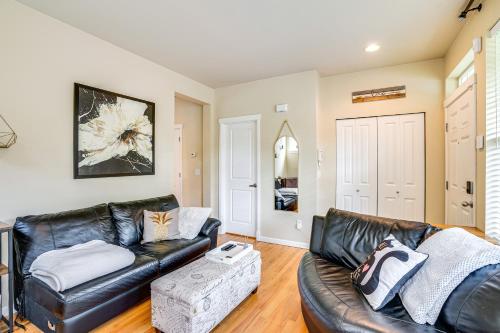 a living room with a black leather couch at 3 Mi to Dtwn Bothell Quaint Family Home with Patio in Bothell
