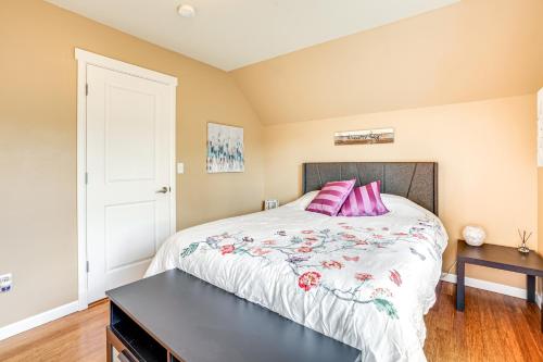 a bedroom with a large bed with pink pillows at 3 Mi to Dtwn Bothell Quaint Family Home with Patio in Bothell