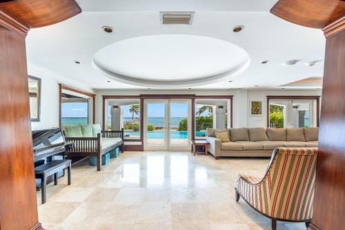 a living room with a couch and a piano at Pease Bay House in Breakers