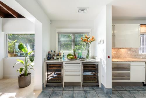 a kitchen with white cabinets and a counter at Pease Bay House in Breakers