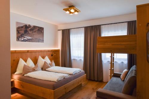 a hotel room with a bed and a window at Brandstatthof Leogang in Leogang