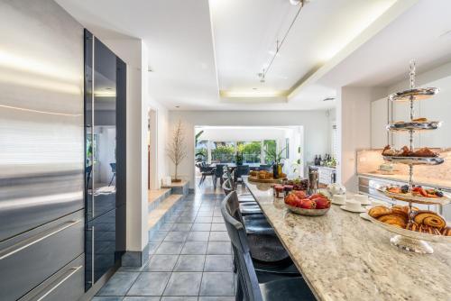 a kitchen with a long table with fruits on it at Pease Bay House in Breakers