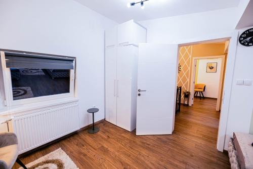 a living room with white walls and a window at Fruška Kuća in Vrdnik