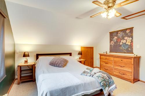 a bedroom with a bed and a dresser and a ceiling fan at Boat, Paddle, UTV and More Getaway in Saint Germain in Saint Germain