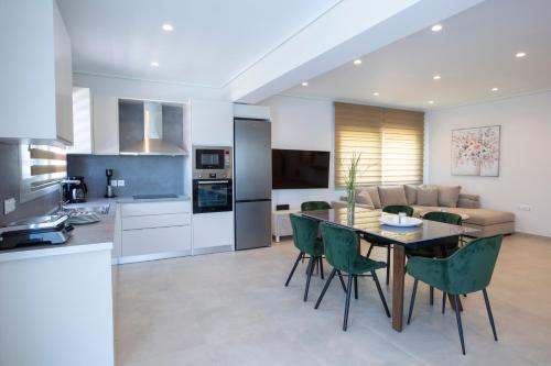 a kitchen and living room with a table and chairs at Emilia Villas in Agios Nikitas