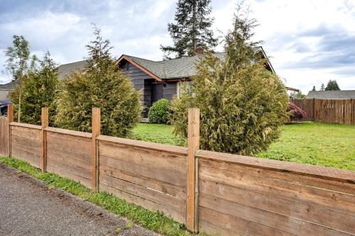 a wooden fence in front of a house at 3 Mi to Emerald Downs Pet-Friendly Home in Auburn