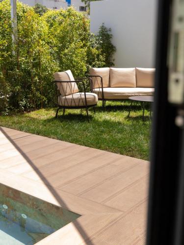 two chairs and a couch sitting in the grass at ananea Tropea Yachting Resort in Tropea